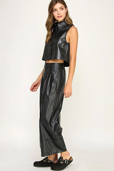 Side view of the Hale Pant showing the relaxed wide-leg fit and sleek black faux-leather finish.