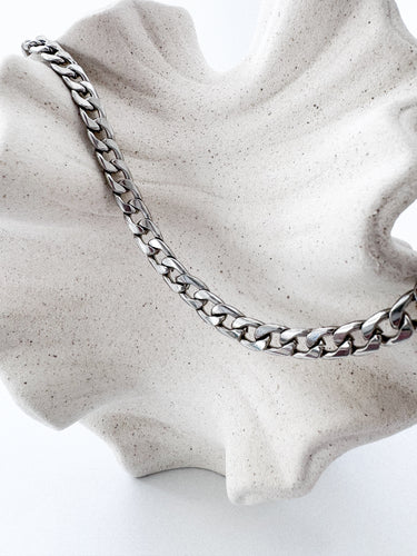 Harika Necklace in silver thick chain design by Matte on textured display stand