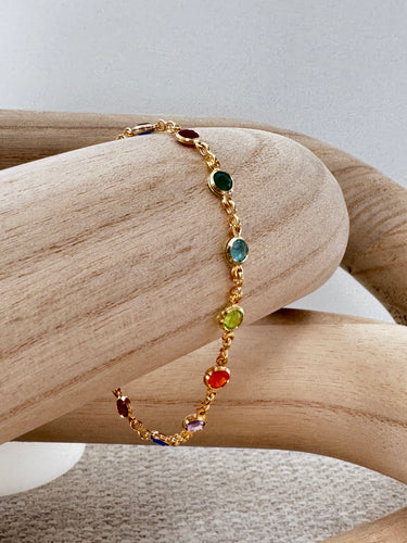 Howl gold chain bracelet with multicolor gemstones on wooden display – Matte jewelry