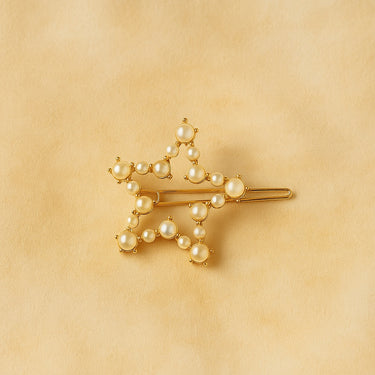 Idle Hair Clip — gold star-shaped hair accessory with pearl details on neutral beige background.