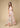 Pastel geometric wide-leg pants styled with matching top, resort-inspired look by the sea.