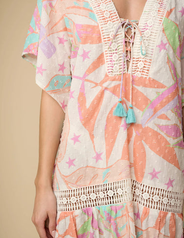 A multicolored floral lace-up cover-up dress with star accents and intricate lace details, displayed on a person.