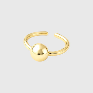 Gold ring with a spherical design on a light gray background