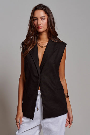 Kaia Vest black longline tailored vest styled with white trousers.