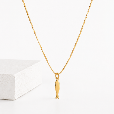 Kimori Necklace gold fish pendant necklace on delicate chain displayed on neutral background