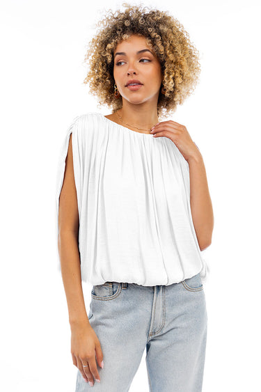 Woman wearing the Kyoto Blouse in white, lightweight draped top with soft pleats and relaxed fit, photographed on clean white background with natural light.