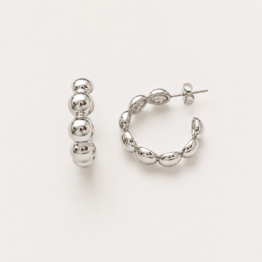 Landen Hoop Earrings featuring polished silver-plated hoop earrings with graduated sphere bead detailing, a rounded hoop silhouette, mirror finish, secure post-back closure, lightweight design, and modern statement style.