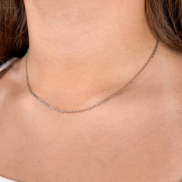 Model wearing Landing silver chain necklace by Matte, flat delicate style