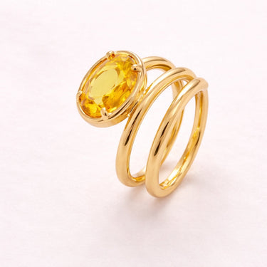 Livona Ring gold multi band sculptural ring with oval cut yellow stone bold statement ring on neutral background