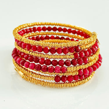 Lolita 6 Loops Bracelet by Matte, gold wire with faceted red gemstone beads.
