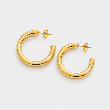 Lorenza Hoop Earrings featuring polished gold-plated classic hoop earrings with a smooth rounded silhouette, mirror finish, secure hinged closure, lightweight design, and timeless everyday style, displayed on a soft white background.