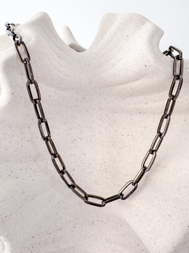 Losa Necklace by Matte, black enamel chain necklace displayed on neutral background