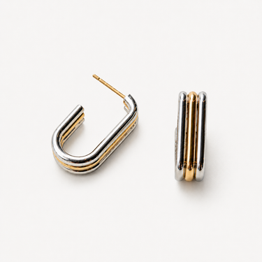 Maia Hoop Earrings featuring a polished two-tone gold and silver finish with a modern rounded silhouette.