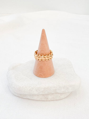 Gold-plated crown-inspired adjustable ring displayed on marble background