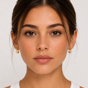 Margo Hoop Earrings mini gold sculptural hoop earrings worn on model with polished finish.