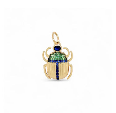 Marina Pendant gold scarab charm with green and blue zirconia details and blue stone center on a clean white background.