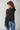 Back view of the Maruk Blouse highlighting its lightweight sheer fabric, flowing silhouette, dramatic bell sleeves, and elegant drape.