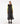 Front view of woman wearing long black hooded puffer vest with quilted design.
