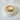Gold-plated pavé snake-inspired ring with crystal detailing on marble surface – Merida Ring by Matte.