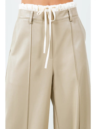 Milano Tie-Waist Pant featuring a high-rise paper-bag waist with adjustable drawstring tie and wide-leg silhouette in a soft neutral faux leather finish.