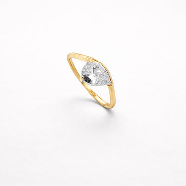 Misuki Ring gold thin band ring with pear cut clear zirconia stone minimalist stacking ring on neutral background.