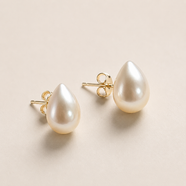 Morath Stud Earrings freshwater pearl teardrop stud earrings with gold posts on neutral background.