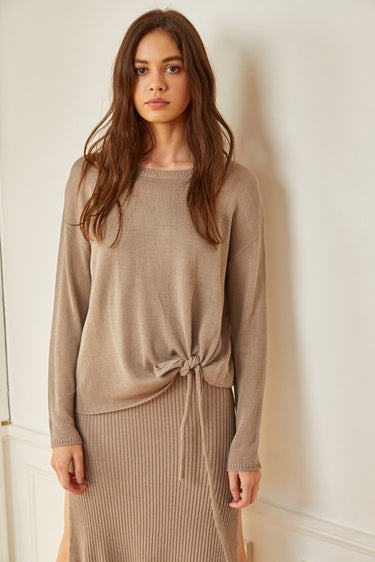 Model wearing the Mur Sweater in a lightweight relaxed knit with a coordinating skirt.