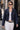 Model wearing Murish Jacket dark-wash denim jacket with white pants.
