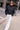 Murish Jacket styled with white pants, front view.