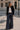Model wearing Murish Trouser dark indigo wide-leg pants with contrast stitching.