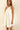 Model wearing Nara Mini Dress in white with halter neckline and relaxed fit.