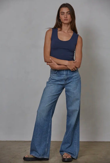 Full-length front view of the Nightjar Top showcasing the sleeveless design, fitted silhouette, scoop neckline, and soft knit fabric paired with relaxed blue jeans.