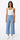 Wide-leg Tencel pants in light blue with relaxed drape and high-rise fit, photographed on a model wearing a white top in a bright neutral studio.
