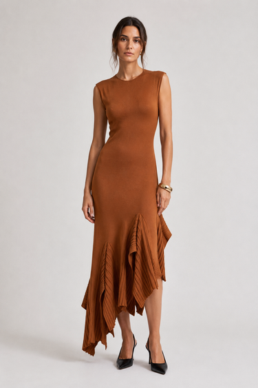 Woman wearing the Pauletti knit midi dress with a fitted silhouette and asymmetric ruffled hem, front view.