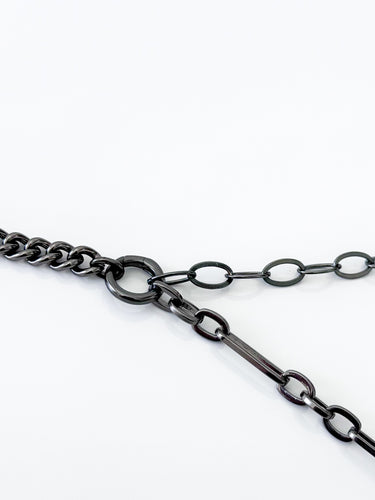 A black enamel necklace with a cuban chain design on a white background.