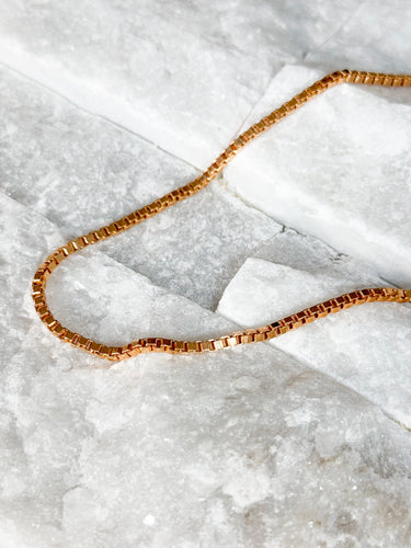Plano Necklace by Matte, gold filled box chain choker on white marble surface