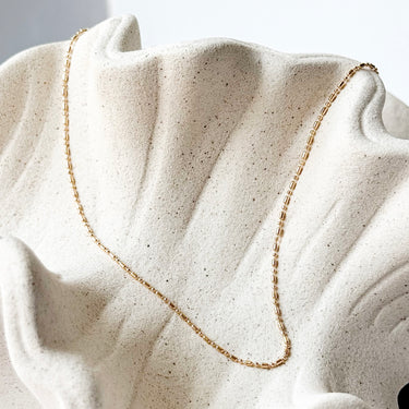 Recife gold plated chain necklace by Matte, fine minimalist chain on neutral fabric