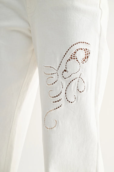 Relic Embroidered Denim Pants – close-up detail of cutwork embroidery on white denim.
