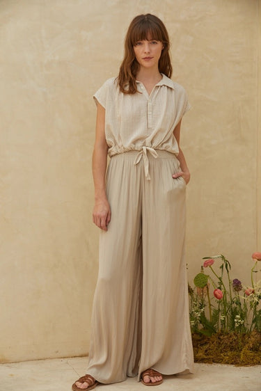 Rita Shirt lightweight striped top styled with wide-leg pants in soft neutral tones.