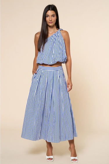 Ritzi Blouse front detail of vertical blue stripes, one shoulder crop top and soft drape fabric on model