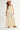 Roblen Pant soft cream wide-leg resort pants front view styled with a lightweight tiered top and wide-brim hat, featuring elastic waistband and flowing silhouette.
