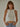Front view of the Romett Top in off white featuring a sleeveless ribbed knit construction, high neckline, cropped fitted shape, and soft stretch fabric for everyday wear.