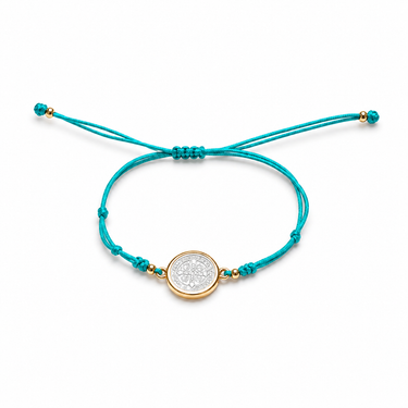 Saint Benedict Bracelet turquoise cord bracelet flat lay showing adjustable closure and central medallion detail.