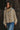 Woman wearing the Sakany lightweight hooded utility jacket in beige, featuring oversized pockets, gathered details, and a relaxed oversized fit.