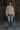 Front full-body view of the Sakany beige hooded utility jacket styled with denim, showcasing its relaxed silhouette and lightweight design.
