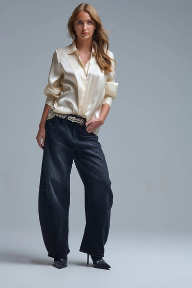 Silky champagne button-down shirt with fluid drape and long sleeves, shown on model styled with dark denim — Sandora Shirt by Matte.
