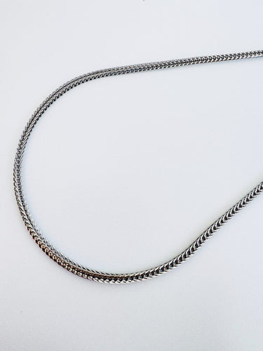 Sawyer necklace by Matte, silver tone gold plated herringbone chain on white background