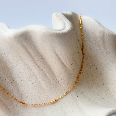 Sequence gold filled chain necklace by Matte, minimalist bar detail chain on neutral fabric
