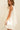 Side view of Nara Mini Dress showing flowy silhouette and sleeveless cut.