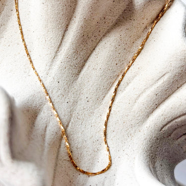 Simplicity gold plated chain necklace by Matte, minimal fine chain on neutral fabric